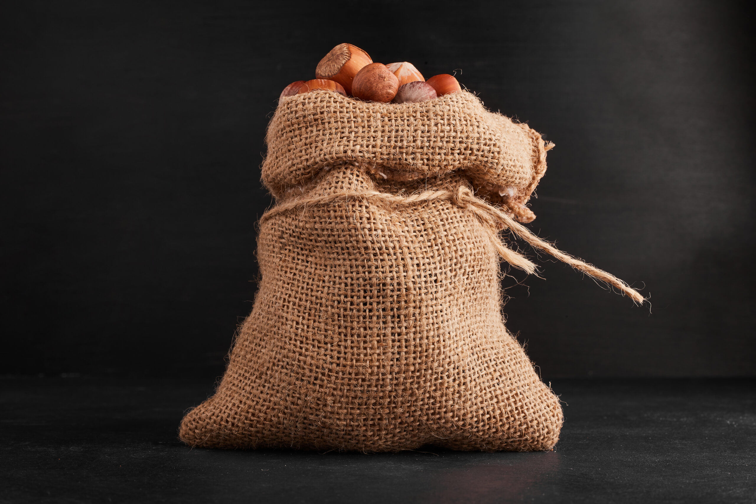 Nut shells on black background in the rustic parcel. High quality photo